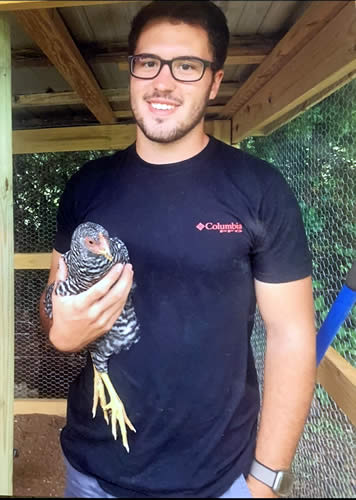 Braxton Bates holding a chicken